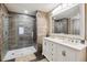 Modern primary bath features a double vanity, walk-in shower with glass door, and tiled walls at 570 Clarendon Loop, Castle Pines, CO 80108