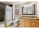 Well-lit bathroom features a vanity with light wood cabinets and granite counters at 570 Clarendon Loop, Castle Pines, CO 80108
