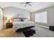 Cozy bedroom with vaulted ceilings, a ceiling fan, and neutral decor at 570 Clarendon Loop, Castle Pines, CO 80108