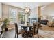 Dining area with a round table, fireplace, and sliding glass doors for ample light at 570 Clarendon Loop, Castle Pines, CO 80108
