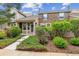 Beautiful exterior view of townhome with lush landscaping, stone details, and inviting entrance at 570 Clarendon Loop, Castle Pines, CO 80108