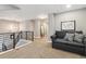 Upstairs hallway featuring a gray couch, carpeted floors, and modern light fixture at 570 Clarendon Loop, Castle Pines, CO 80108