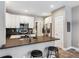 Stylish kitchen with stainless steel appliances, dark backsplash, and a breakfast bar at 570 Clarendon Loop, Castle Pines, CO 80108