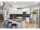 Modern kitchen with stainless steel appliances, a breakfast bar, and white cabinets at 570 Clarendon Loop, Castle Pines, CO 80108