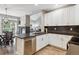 Bright kitchen with stainless steel appliances, dark countertops, and white cabinets at 570 Clarendon Loop, Castle Pines, CO 80108