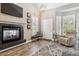 Cozy living room featuring a fireplace, neutral colors, and lots of natural light at 570 Clarendon Loop, Castle Pines, CO 80108
