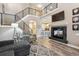Inviting living room featuring a fireplace, staircase, and open layout to the kitchen at 570 Clarendon Loop, Castle Pines, CO 80108
