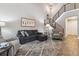 Bright living room with modern furniture, an open staircase, and wood flooring at 570 Clarendon Loop, Castle Pines, CO 80108