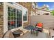 Private stone patio features outdoor seating and access to interior through sliding glass door at 570 Clarendon Loop, Castle Pines, CO 80108