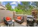 Cozy patio with stone accents, outdoor seating, and a grill, perfect for entertaining at 570 Clarendon Loop, Castle Pines, CO 80108