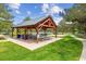 Community pavilion with picnic tables and grassy area, perfect for outdoor gatherings and recreation at 570 Clarendon Loop, Castle Pines, CO 80108