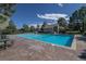Community pool surrounded by lush greenery offers a refreshing escape on warm days at 570 Clarendon Loop, Castle Pines, CO 80108