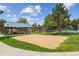 Community sand volleyball court with net, pavilion, grass, and trees for active recreation at 570 Clarendon Loop, Castle Pines, CO 80108