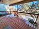 Wooden deck overlooks a fenced backyard with winter scene at 18874 E Ida Ave, Aurora, CO 80015