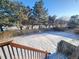 Spacious backyard covered in snow, offering a private and serene landscape at 18874 E Ida Ave, Aurora, CO 80015