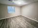 Spacious basement bedroom with wood-look flooring and a window at 18874 E Ida Ave, Aurora, CO 80015