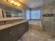 Elegant bathroom with double vanity, soaking tub, and shower at 18874 E Ida Ave, Aurora, CO 80015