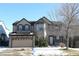 Two-story house with beige and brick exterior, attached garage, and landscaping at 18874 E Ida Ave, Aurora, CO 80015