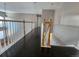 Upstairs hallway with dark hardwood floors and white railings at 18874 E Ida Ave, Aurora, CO 80015