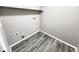 Convenient laundry room with vinyl flooring and shelving at 18874 E Ida Ave, Aurora, CO 80015