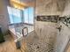 Large walk-in shower with marble tile and glass enclosure at 18874 E Ida Ave, Aurora, CO 80015