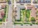 Aerial view of the property showcasing the layout, lush green lawns, mature trees, and neighborhood at 4201 Shoshone St, Denver, CO 80211