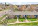 Aerial perspective showcases lush lawns and blue doors enhancing the beauty of the home's facade at 4201 Shoshone St, Denver, CO 80211