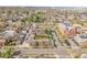 Expansive aerial shot capturing the community with tree-lined streets and multi-Gathering housing near a school at 4201 Shoshone St, Denver, CO 80211