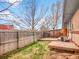 Fenced backyard features a grassy area and wooden deck, perfect for enjoying outdoor living at 4201 Shoshone St, Denver, CO 80211