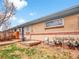 Exterior backyard view showing brick building, wooden decks, and grassy space enclosed by wooden fences at 4201 Shoshone St, Denver, CO 80211