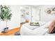 Inviting bedroom with a mirrored closet, wood floors, a decorative tree, and natural light at 4201 Shoshone St, Denver, CO 80211