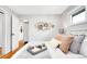 Charming bedroom with natural light, decorative wall art, and a cozy white comforter at 4201 Shoshone St, Denver, CO 80211