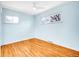Empty bedroom showcasing light blue walls, hardwood floors, and lots of natural light at 4201 Shoshone St, Denver, CO 80211