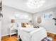 Bright bedroom with white comforter, hardwood floors, and lots of natural light from large windows at 4201 Shoshone St, Denver, CO 80211
