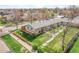 Charming exterior view of the home, featuring a well-kept lawn, fenced yard, and mature trees at 4201 Shoshone St, Denver, CO 80211