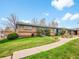 Well-maintained exterior with a lush lawn and walkway that leads to the building, providing a welcoming view at 4201 Shoshone St, Denver, CO 80211
