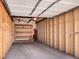 Spacious garage with high ceilings, shelving for storage, and concrete floors; ideal for parking and projects at 4201 Shoshone St, Denver, CO 80211