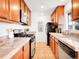 Galley kitchen featuring stainless steel appliances, granite countertops, and ample cabinet space at 4201 Shoshone St, Denver, CO 80211