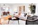 Open living room with dining area, showcasing stylish decor, wood floors, and a comfortable seating arrangement at 4201 Shoshone St, Denver, CO 80211