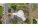Aerial view of a unique home design with lush landscaping, mature trees, expansive driveway and backyard at 6681 S Abilene Way, Centennial, CO 80111