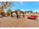 Large wooden deck features an outdoor living space with gazebo, lounge chairs, and a unique round sofa at 6681 S Abilene Way, Centennial, CO 80111