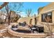 Backyard patio includes an outdoor dining set and lounge chairs provides an intimate space for outdoor gatherings at 6681 S Abilene Way, Centennial, CO 80111