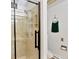 Bathroom features a glass shower, with a mounted shower head, and sleek black fixtures at 6681 S Abilene Way, Centennial, CO 80111