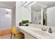 Well-lit bathroom with a spacious vanity area, stylish sink, and a glimpse of the shower at 6681 S Abilene Way, Centennial, CO 80111
