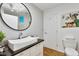 Bathroom features a modern sink, a large mirror, contemporary lighting, and stylish design at 6681 S Abilene Way, Centennial, CO 80111