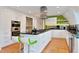 Bright modern kitchen features stainless steel appliances, an island with bar seating, and sleek countertops at 6681 S Abilene Way, Centennial, CO 80111