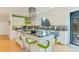 Modern kitchen with stainless steel appliances, an island with bar seating, and stylish countertops at 6681 S Abilene Way, Centennial, CO 80111