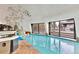 Indoor pool features a hot tub, adjacent lounging area, and large windows overlooking the outdoors at 6681 S Abilene Way, Centennial, CO 80111