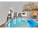 Indoor pool boasts seating area, sleek lighting, and unique architecture with beautiful design elements at 6681 S Abilene Way, Centennial, CO 80111