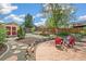 Inviting backyard with a stone patio, lush landscaping, and a charming storage shed at 2170 W Warren Ave, Englewood, CO 80110